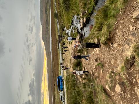 People taking photos in a scenic landscape.