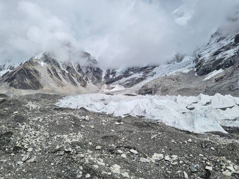 Snowy mountainous landscape with rugged terrain.