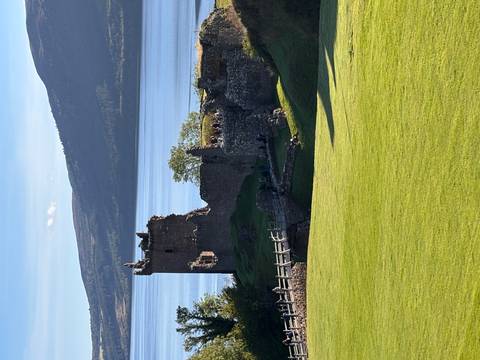       Ruins of a stone castle overlooking a body of water.
  