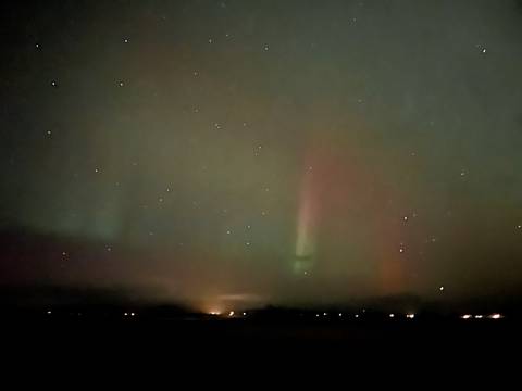 Aurora borealis with a night sky filled with stars.