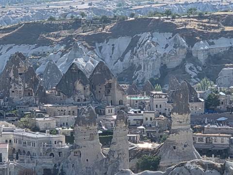 Rock formations and traditional houses in a historic town.