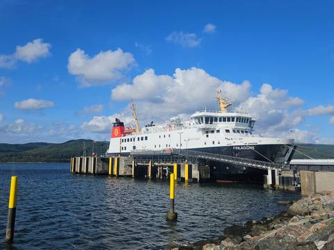 Ferry docked at a pier with the name 'Finlaggan' visible.