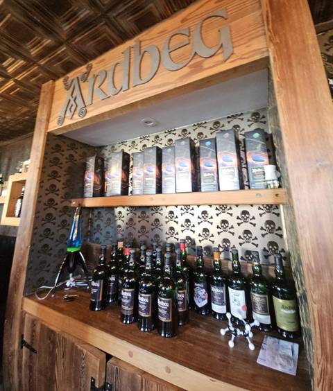       Shelves lined with whiskey bottles and boxes.
  