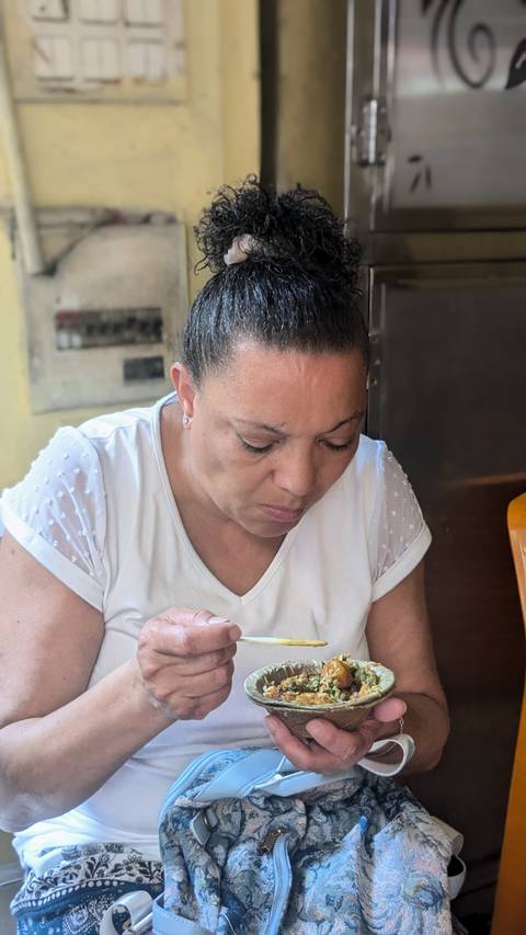       Close-up of a woman in a white shirt looking down.
  