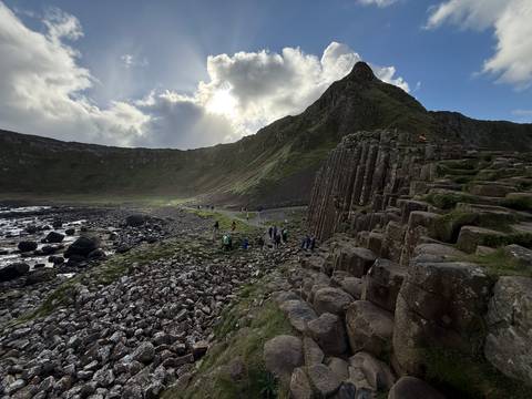 Giant's Causeway with people walking among the rock formations.