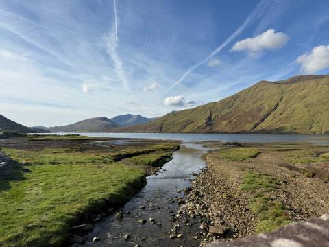 Serene lake with mountains in the background.