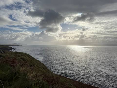 Seascape with dramatic clouds and ocean waves.