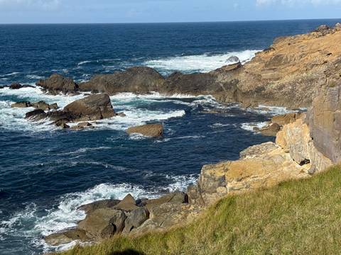 Rocky shoreline with waves crashing.