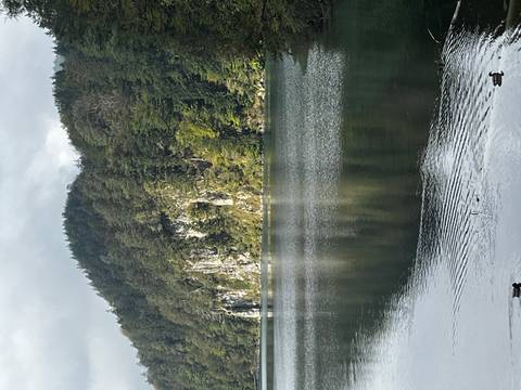 Scenic lake with cliffs and forests.