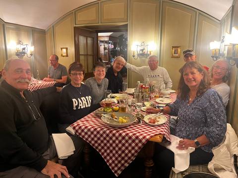 Group of people dining in a cozy restaurant setting.