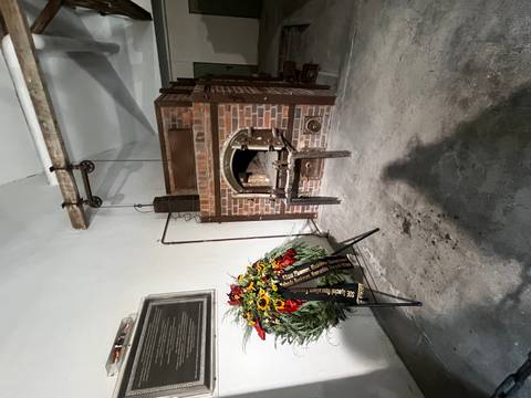 Memorial within a former crematorium area with flowers in Dresden.