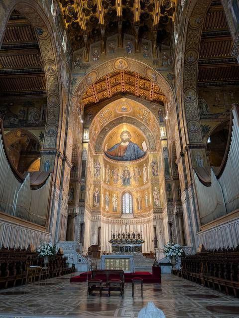       Interior of a cathedral with ornate ceiling mosaics
  