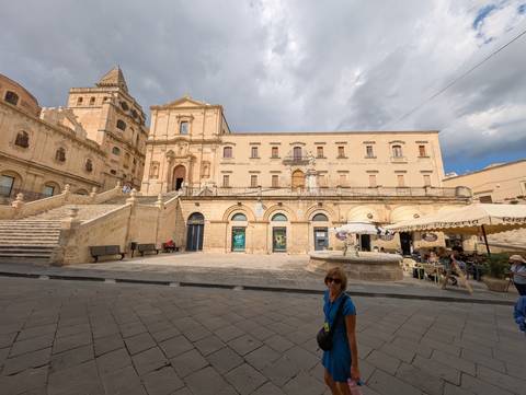 Historic building with stairs and archways in a town square