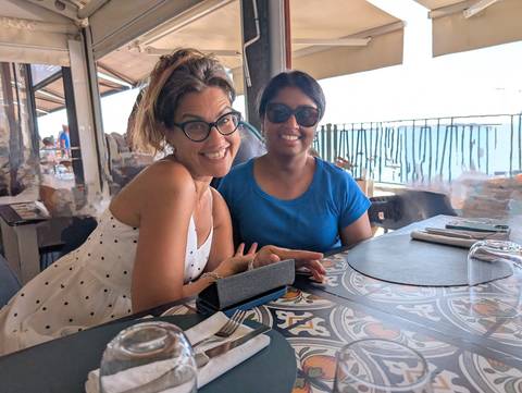       Two women sitting at a table in a restaurant
  