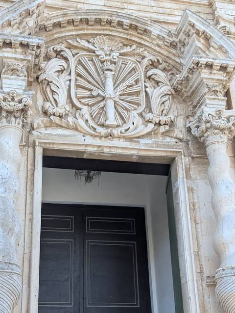       Carved stone details above an entrance
  