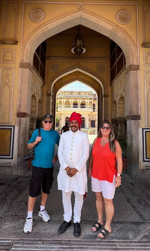 Couple posing with a local man in traditional attire