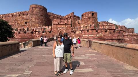Couple standing in front of Agra Fort