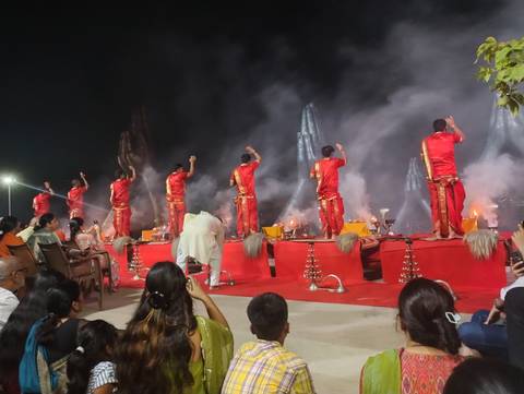 A nighttime ceremony with performers in red costumes.