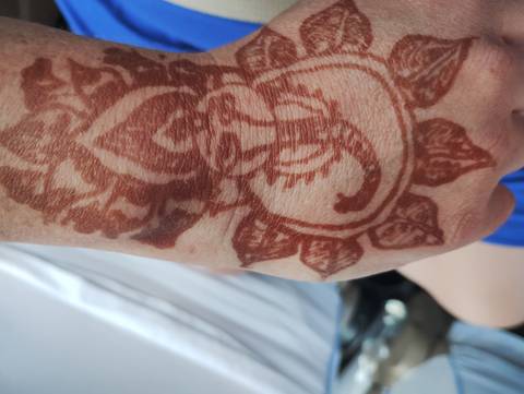 Henna tattoo with intricate patterns on a hand.