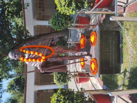 Statue of Mahatma Gandhi adorned with marigold garlands.