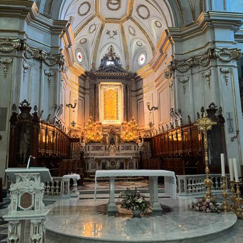       Richly decorated church interior with altar and religious iconography.
  