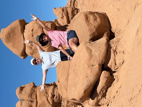 Two women posing on rocky formations.