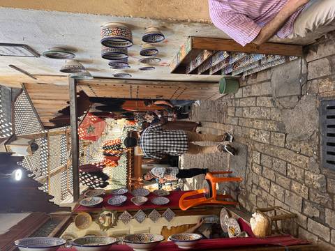 Busy marketplace with shops selling pottery and other goods.