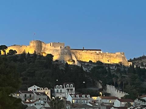 Historic fortress illuminated at night.
