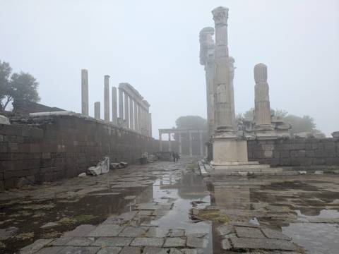       Ancient ruins in a foggy setting.
  