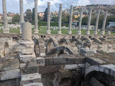       Ancient columns with city backdrop.
  