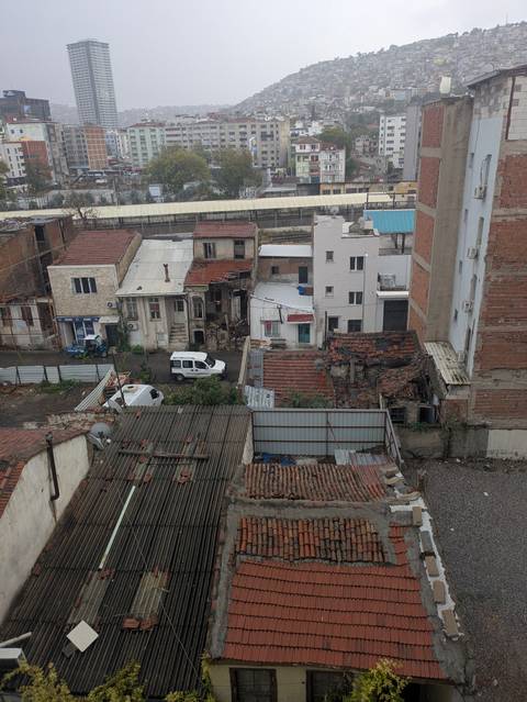       View of worn-down buildings and rooftops.
  