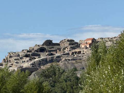       Ancient cave city carved into rocky hills.
  