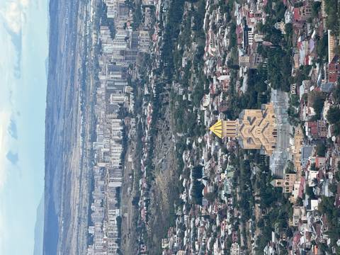 A panoramic view of a city with a prominent cathedral and surrounding buildings.