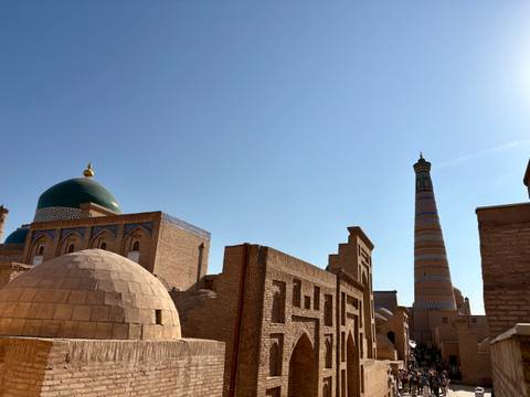 Old city with domes and a tall minaret.