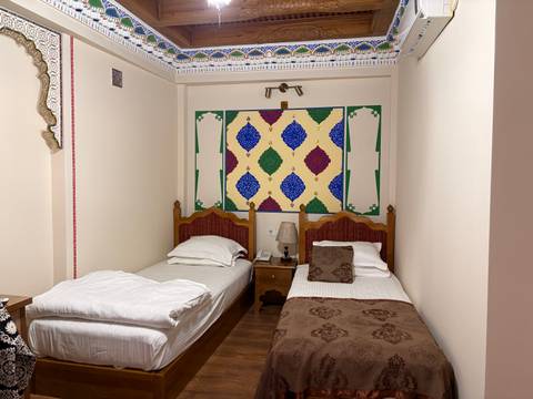       Traditional bedroom with two single beds.
  