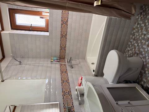 Bathroom with a bathtub and patterned tiles.