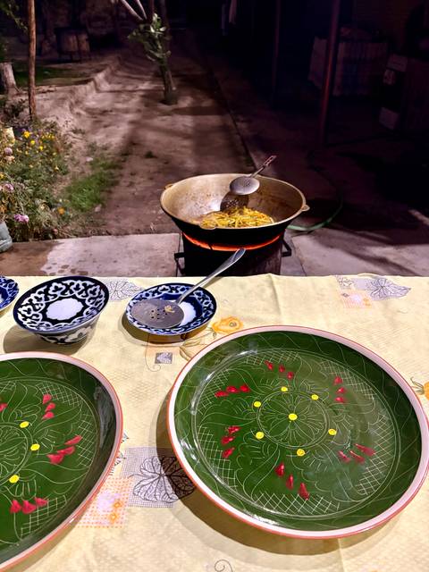 Outdoor cooking setup with plates and utensils.