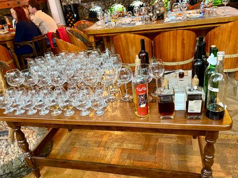       Table with wine glasses and bottles in a restaurant setting.
  