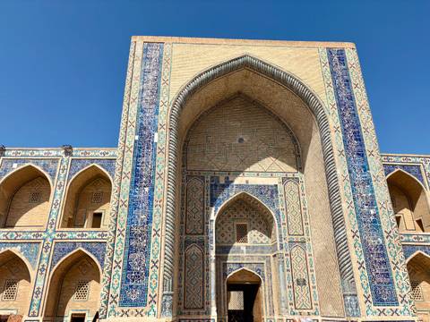 Large mosque entrance with detailed tilework.