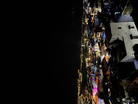       Night view over a city with lit buildings.
  