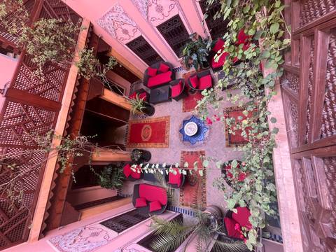 A colorful courtyard with seating and decorative plants.