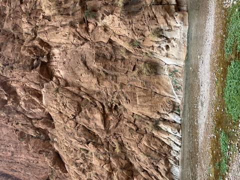 Rock formation with a stream flowing through the canyon.