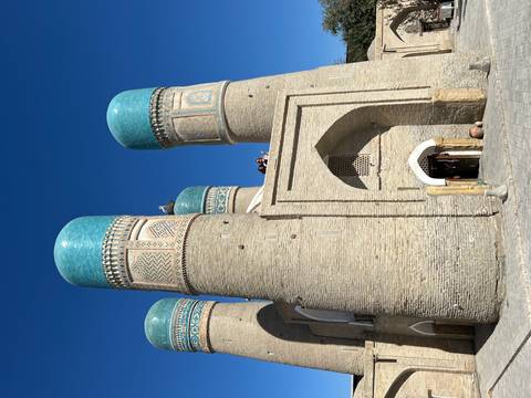 Historic madrasah with turquoise domes.