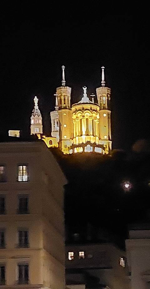 Blurry image of a lit building at night.