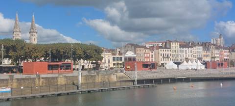 Riverside town with a row of colorful buildings.
