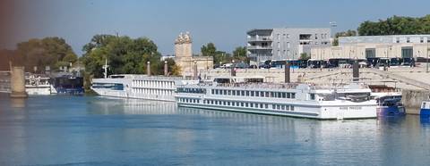 Two river cruise boats docked at a port.