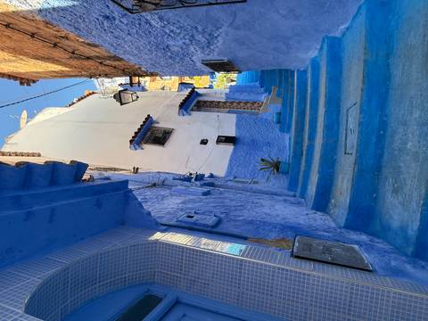       Cityscape view featuring a prominent mosque minaret at sunset.
  