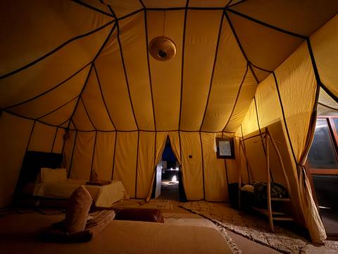      Artisan working on a model ship in a workshop.
  