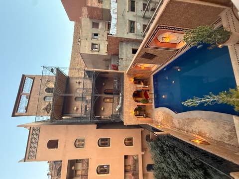       Elegant dining room with ornate ceilings and candlelit tables.
  