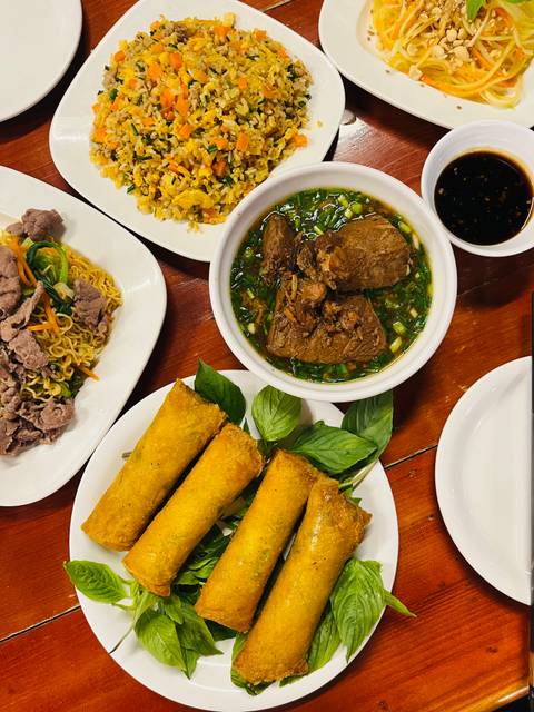       Plate of various Vietnamese dishes including spring rolls and noodles.
  